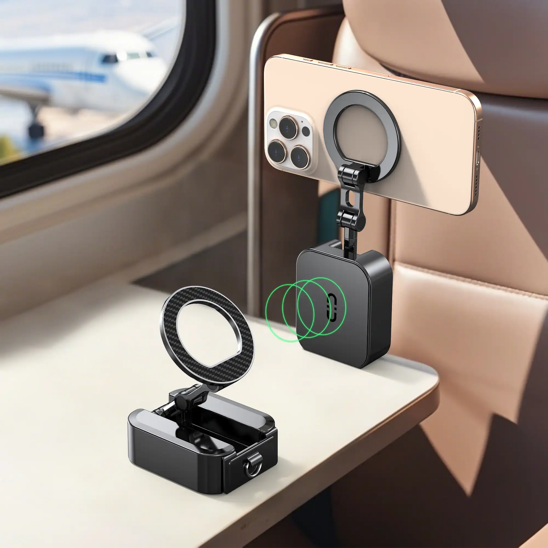 The portable phone stand used as a travel accessory on an airplane, with one unit folded on the tray table and another mounted to the seat back, holding a phone for hands-free entertainment during the flight.