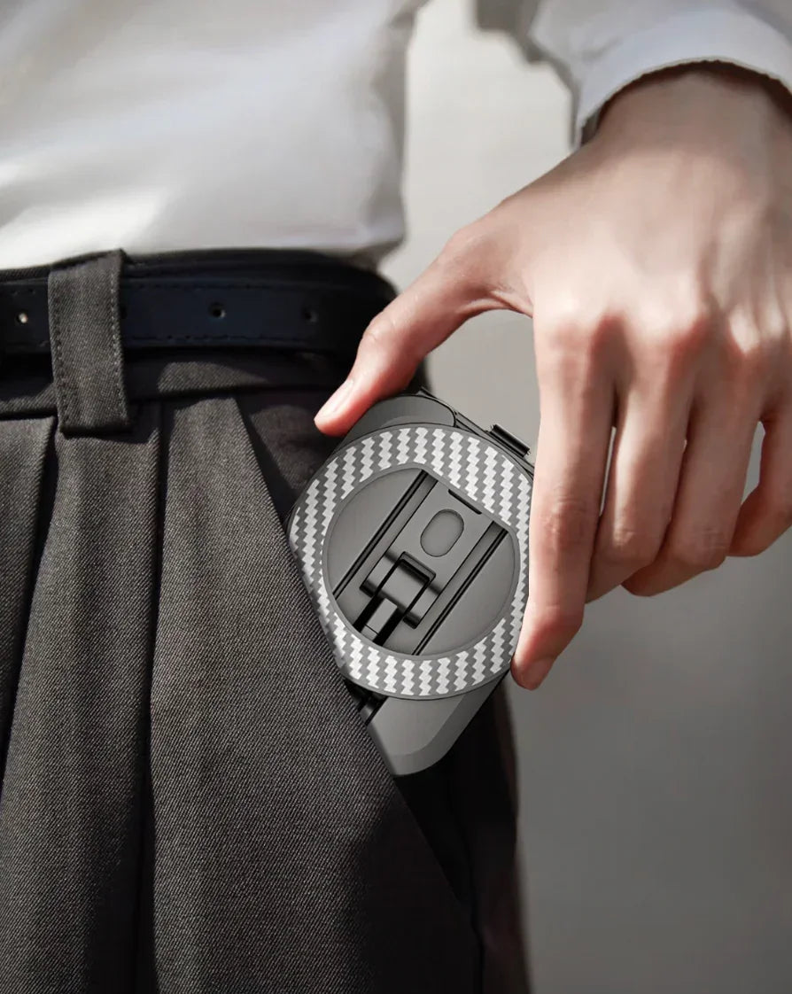 A person easily sliding the slim, folded phone stand into the front pocket of their trousers, demonstrating its compact and portable design for on-the-go use.