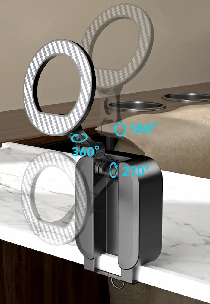 Two black magnetic phone stands are displayed on an airplane tray table; one is folded, and the other is propped open holding a smartphone